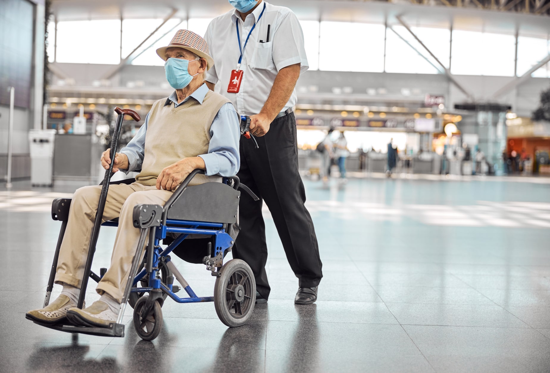 Nassau staff member assisting elder in a wheelchair