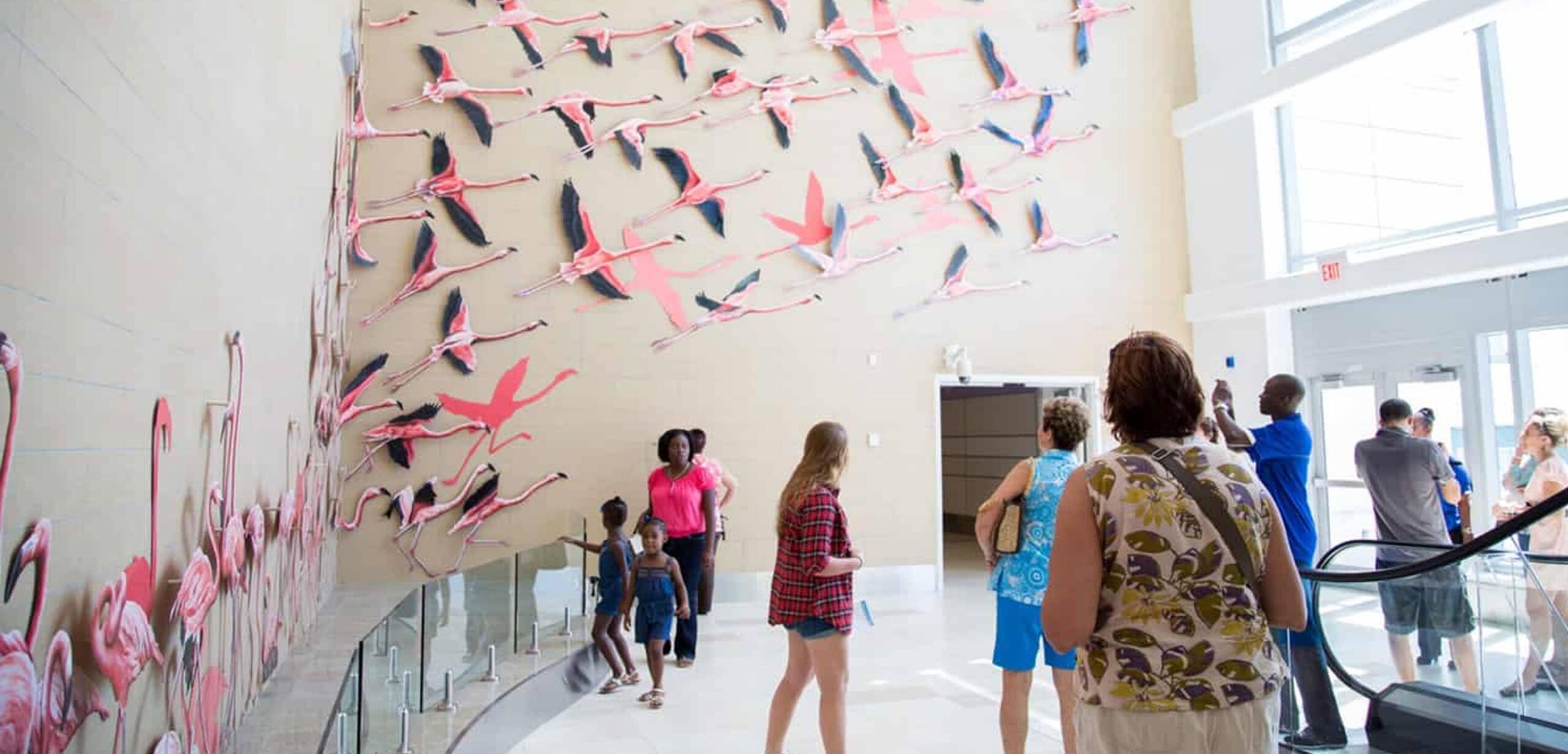 Image of the take flight artwork. A flock of flying flamingos.