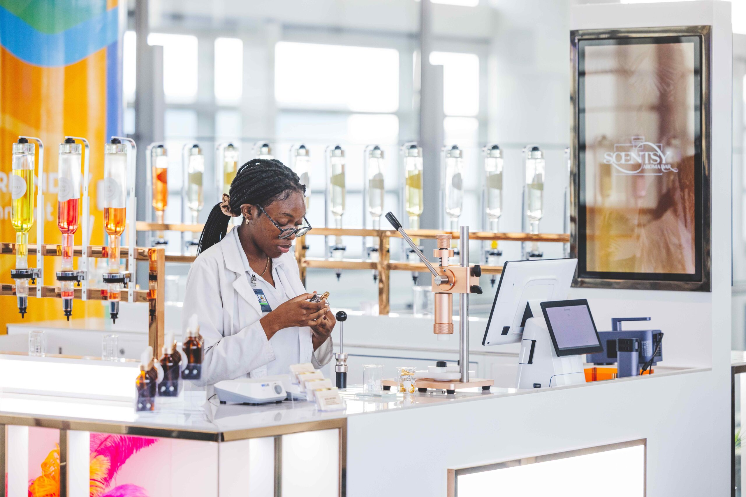 A worker inside of scentsy, examining a product.